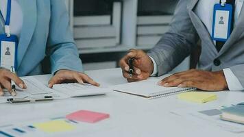 Group of coworkers in formal wear sitting at table in conference room and arguing about project of company development during meeting video