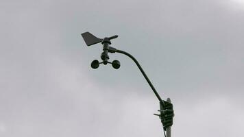 Weather vane and wind gauge for direct and strength. Stormy clouds in the backgeound. video