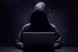 Anonymous hacker without face typing computer laptop. Concept of hacking cybersecurity, cybercrime, cyberattack, etc. photo