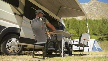 Man Using Internet While on Camping in Some Remote Place Between Mountains video