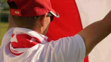Polish Soccer Fan Wearing National Team Colors Playing with Polish Flag on Wind. Slow Motion Footage video