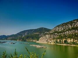 warm sunny morning in the Turki mountains above a green blue calm large lake photo