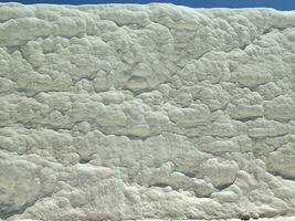 natural limestone background with traces of water from Pamukkale in Turkey in close-up photo