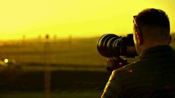 Caucasian Videographer Taking Video in the Field.