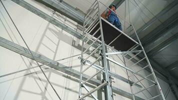 Caucasian Contractor Worker on a Scaffolding Equipment. video