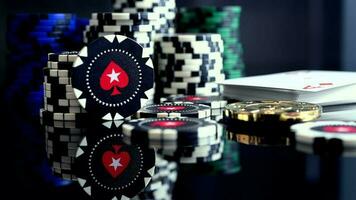 Stack Of Colorful Chips For Casino And Deck Of Playing Cards With Ace On Top On Black Glass Table With Reflection. video