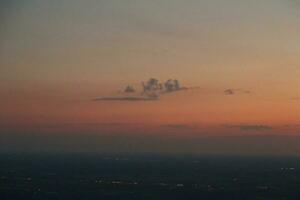 mysterious sunset with clouds from the airplane window with photo