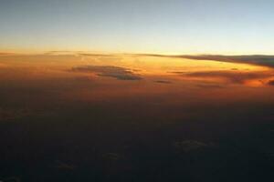 mysterious sunset with clouds from the airplane window with photo