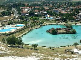 original Pamukkale place in Turkey in Asia landscape with limestone pools with blue warm water photo