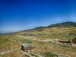 old ruins of the Roman spa city of Hierapolis on the site of the current poison on a warm summer sunny day photo