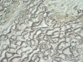 natural limestone background with traces of water from Pamukkale in Turkey in close-up photo