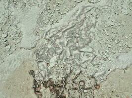 natural limestone background with traces of water from Pamukkale in Turkey in close-up photo