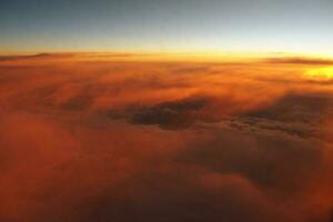 mysterious sunset with clouds from the airplane window with photo