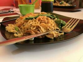 selective focus of chicken noodles and vegetables. photo