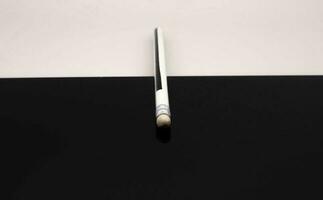 pencil on glass black and white background for marketing and communication advertising photo