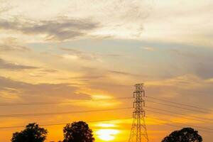 Silhouette High voltage electric tower on sunset time, sky on sunset time background photo