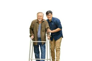 Senior asian father and middle aged son with clipping path, Caregiver is teaching old man to walk with walker, Elderly senior man with son on white background photo