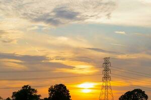 Silhouette High voltage electric tower on sunset time, sky on sunset time background photo