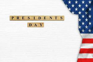 Happy Presidents' Day on white wood background with American flag border. photo