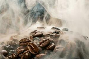 Coffee beans roasting with smoke,  selective focus, and soft focus. photo