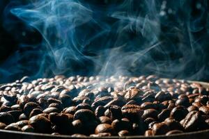 Coffee beans roasting with smoke,  selective focus, and soft focus. photo