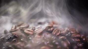 Coffee beans roasting with smoke,  selective focus, and soft focus. photo