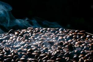 Coffee beans roasting with smoke,  selective focus, and soft focus. photo