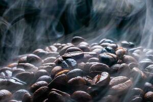 Coffee beans roasting with smoke,  selective focus, and soft focus. photo