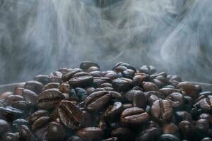 Coffee beans roasting with smoke,  selective focus, and soft focus. photo