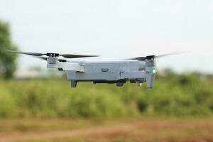 Bogor, Indonesia - 2022. a photo of a drone flying with a blurry propeller against a green open space background. technology photo concept.