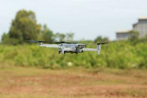 Bogor, Indonesia - 2022. a photo of a drone flying with a blurry propeller against a green open space background. technology photo concept.