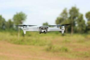 Bogor, Indonesia - 2022. a photo of a drone flying with a blurry propeller against a green open space background. technology photo concept.