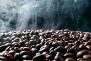 Coffee beans roasting with smoke,  selective focus, and soft focus. photo