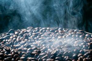 Coffee beans roasting with smoke,  selective focus, and soft focus. photo