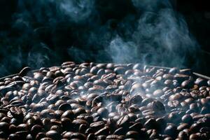 Coffee beans roasting with smoke,  selective focus, and soft focus. photo