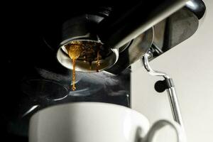 Close-up of espresso pouring from a coffee machine, inside the house,  Close-up of espresso pouring from a coffee machine, inside the house photo