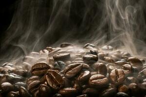 Coffee beans roasting with smoke,  selective focus, and soft focus. photo