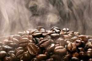 Coffee beans roasting with smoke,  selective focus, and soft focus. photo