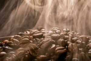 Coffee beans roasting with smoke,  selective focus, and soft focus. photo