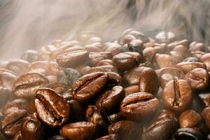 Coffee beans roasting with smoke,  selective focus, and soft focus. photo