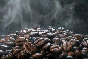 Coffee beans roasting with smoke,  selective focus, and soft focus. photo