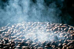 Coffee beans roasting with smoke,  selective focus, and soft focus. photo