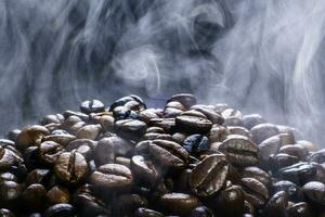 Coffee beans roasting with smoke, dark roast coffee,  selective focus, and soft focus. photo