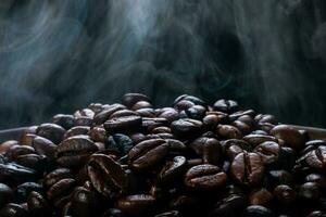 Coffee beans roasting with smoke,  selective focus, and soft focus. photo