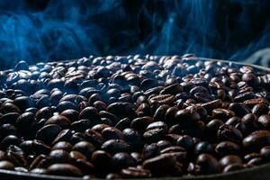 Coffee beans roasting with smoke,  selective focus, and soft focus. photo