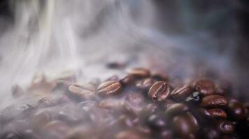 Coffee beans roasting with smoke,  selective focus, and soft focus. photo