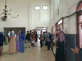 Tegal, May 2023. The atmosphere at Tegal train station was full of people queuing to check their tickets to get into the train carriages in the morning. photo