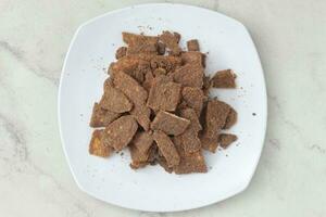 banana chips with cocoa powder served on a white plate photo