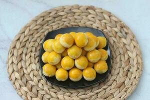 nastar cookies, pineapple tarts or nanas tart are small, bite-size pastries photo