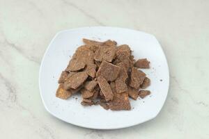 banana chips with cocoa powder served on a white plate photo